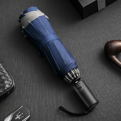 Blue umbrella with black handle on a dark textured surface